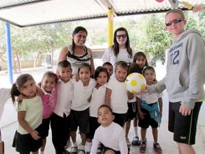 Friends donating  soccer balls in Quimixto