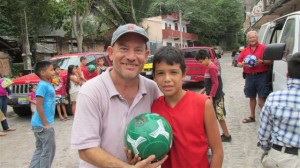 Ran and Eddie giving soccer balls